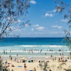 Horizontal Seascape of people enjoying the summer sun on busy tourist beach holiday with sand turquoise waves blue sky at famous surf ocean Byron Bay Australia
1307543414
CLEARED FOR DIGITAL USE ONLY -