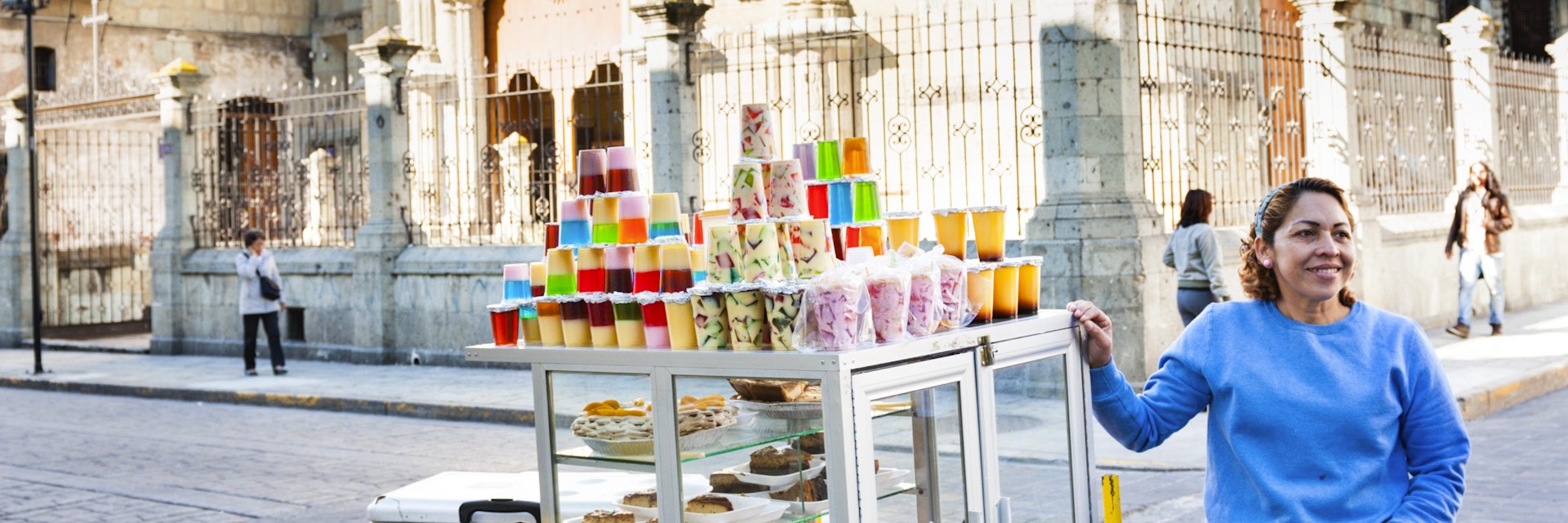 Woman selling Oaxacan deserts from food cart.