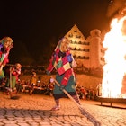 19 February 2020, Baden-Wuerttemberg, Aulendorf: Corner witches of the fool guild Aulendorf dance around a fire in the early evening below the castle. The mystical mask conjuration at the Hexeneck is part of the foolish tradition. That night the fools awoke from their sleep. Until Ash Wednesday the fool's freedom is now valid in the tranquil Upper Swabian town of Aulendorf. Photo: Felix Kästle/dpa (Photo by Felix Kästle/picture alliance via Getty Images)