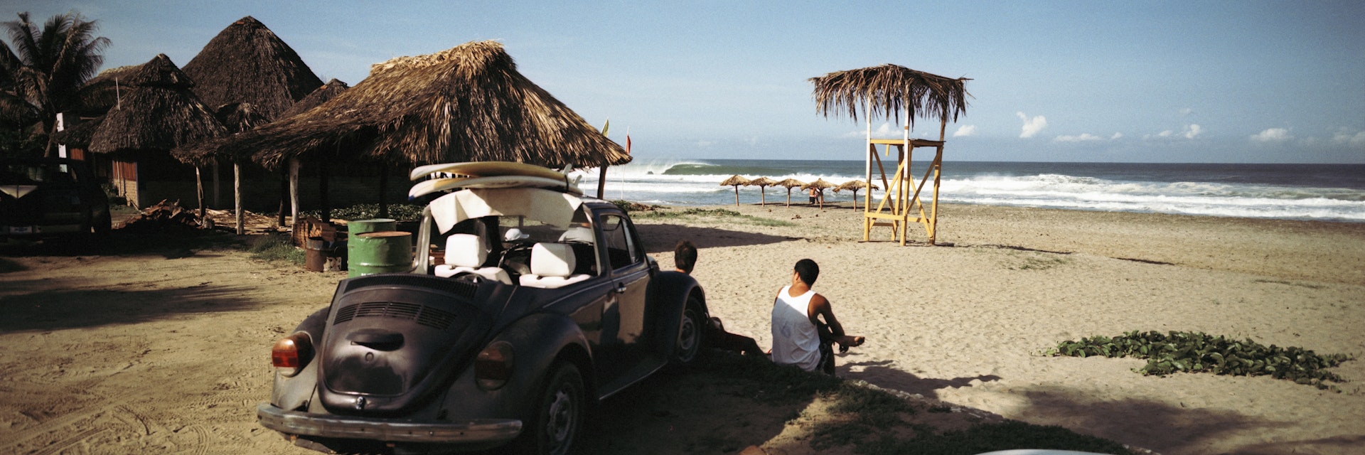 Surfers watching waves, Zicatela Beach, Mexico