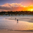 456482477
Colourful setting sun at Wells-Next-the-sea on the North Norfolk coast. Image shows people walking along the waters edge of an incoming tide starting to cover up the beach with the beach huts and forest in the background.
Colourful setting sun at Wells-Next-the-sea on the North Norfolk coast. Image shows people walking along the waters edge of an incoming tide starting to cover up the beach with the beach huts and forest in the background.