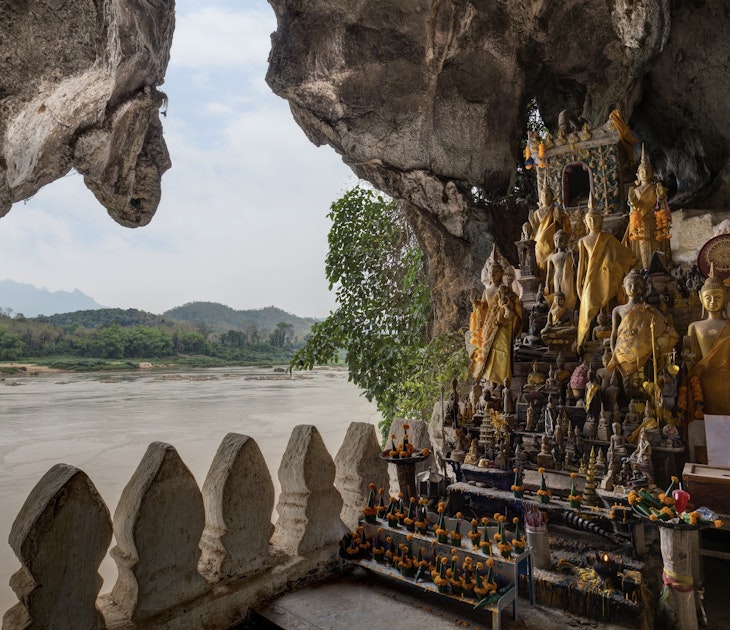 View of the Mekong River and many golden and wooden Buddha statues and religious offerings inside the Tham Ting Cave at the famous Pak Ou Caves near Luang Prabang in Laos.
956152240
View of the Mekong River and many golden and wooden Buddha statues and religious offerings inside the Tham Ting Cave at the famous Pak Ou Caves near Luang Prabang in Laos.