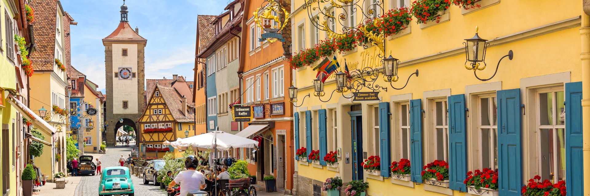 July 11, 2016: Schmiedgasse street in the historic old town of Rothenburg ob der Tauber during summer.
609040148
Cityscape, Architecture, 125282, Built Structure, The Past, Scenics - Nature, Tower, Germany, Ancient, Tourism, Building Exterior, City, European Culture, Travel Destinations, Horizontal, UNESCO World Heritage Site, Old, No People, Day, Rothenburg, Photography, Clock Tower, Bavaria, Village, Multi Colored, Sunny, Gate, Full Frame, Summer, Fort, Color Image, Outdoors, Ouse River, Romance, Medieval, Europe, Famous Place, Idyllic, National Landmark, German Culture, City Life, Town, History, Upper Bavaria, Sunlight, Photograph, Cute, Cultures, Travel, Sky, 2000-2009