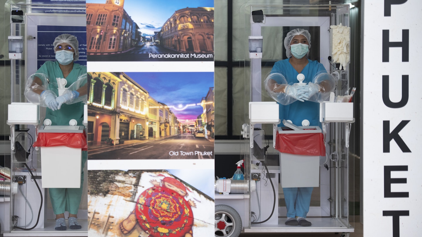 PHUKET, THAILAND - JULY 01: Healthcare workers wait for arriving international passengers to provide coronavirus swab testing at Phuket International Airport on July 01, 2021 in Phuket, Thailand. Starting on July 1, Phuket, a Thai tropical resort island and one of the top travel destinations in the southeast Asia region opens up for foreign tourists who are fully vaccinated against coronavirus to visit without quarantine for the Phuket Sandbox tourism scheme. (Photo by Sirachai Arunrugstichai/Getty Images)