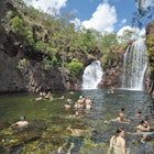 Unidentified people enjoy a swim in the natoral pool of Florence falls in Litchfield Park.